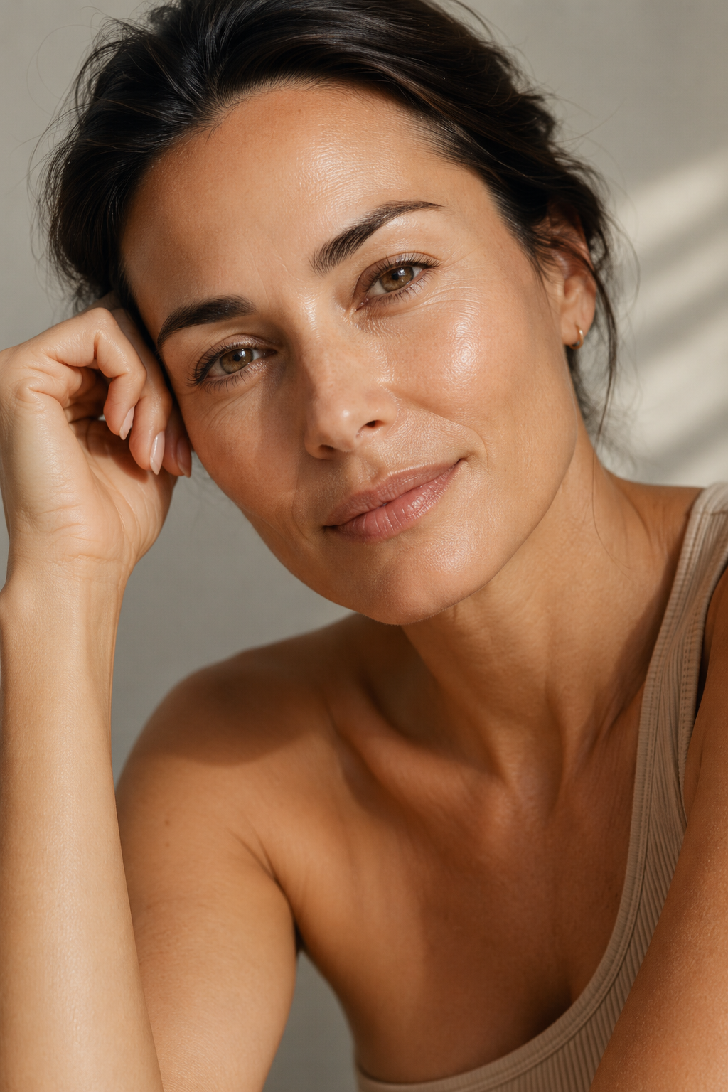 Woman smiling warmly with glowing, healthy skin