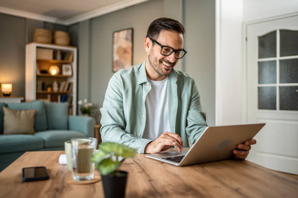 Man completing a medical intake questionnaire on his laptop at home